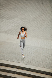 Fit woman sprinting in the city