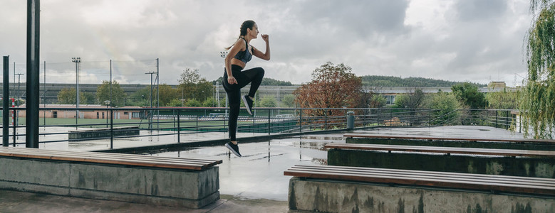 Girl jumping on benches doing training