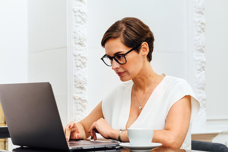 Caucasian woman typing on laptop