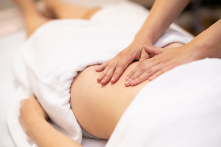 Woman receiving a belly massage in a physiotherapy center