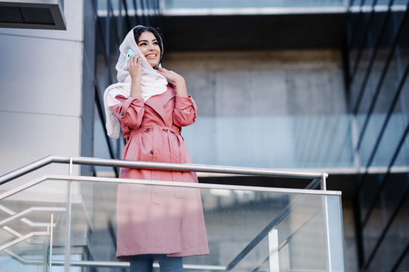 Young Muslim woman wearing hijab using her smartphone