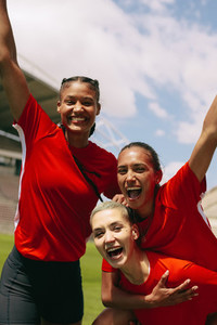 Female soccer team celebrating a victory