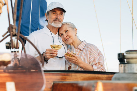 Mature couple standing on yacht