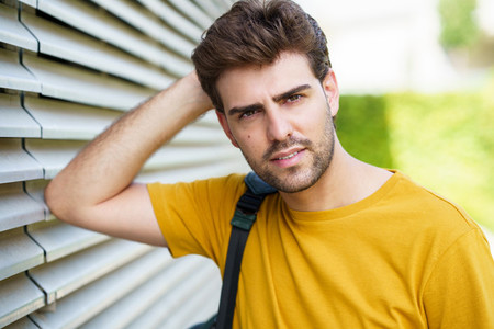 Young man with modern haircut in urban background