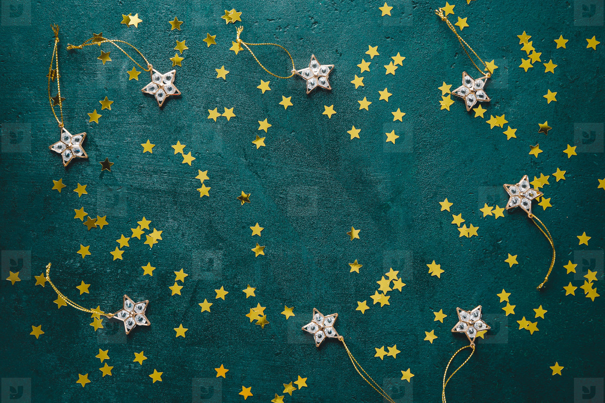 The New Year or Christmas festive flat lay with golden stars over a dark green background  Top view  copy space