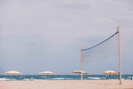 Empty beach with sunbeds an umbrellas
