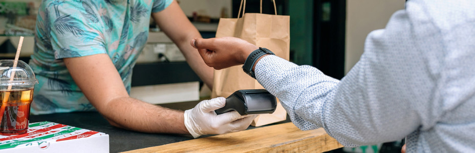 Unrecognizable man paying with smartwatch