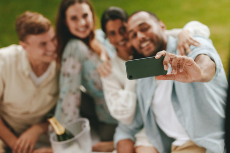 Group of young people on picnic taking a selfie