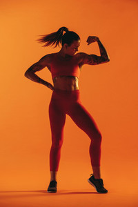 Muscular woman showing biceps