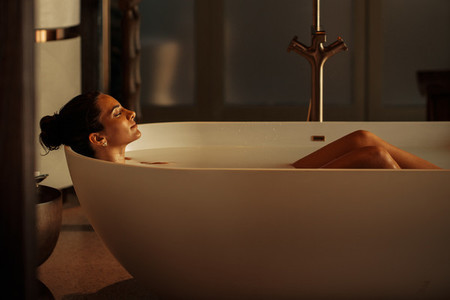Woman lying in a luxury bathtub