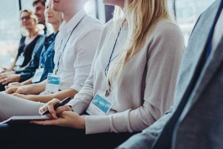 Group of businesspeople sitting at seminar