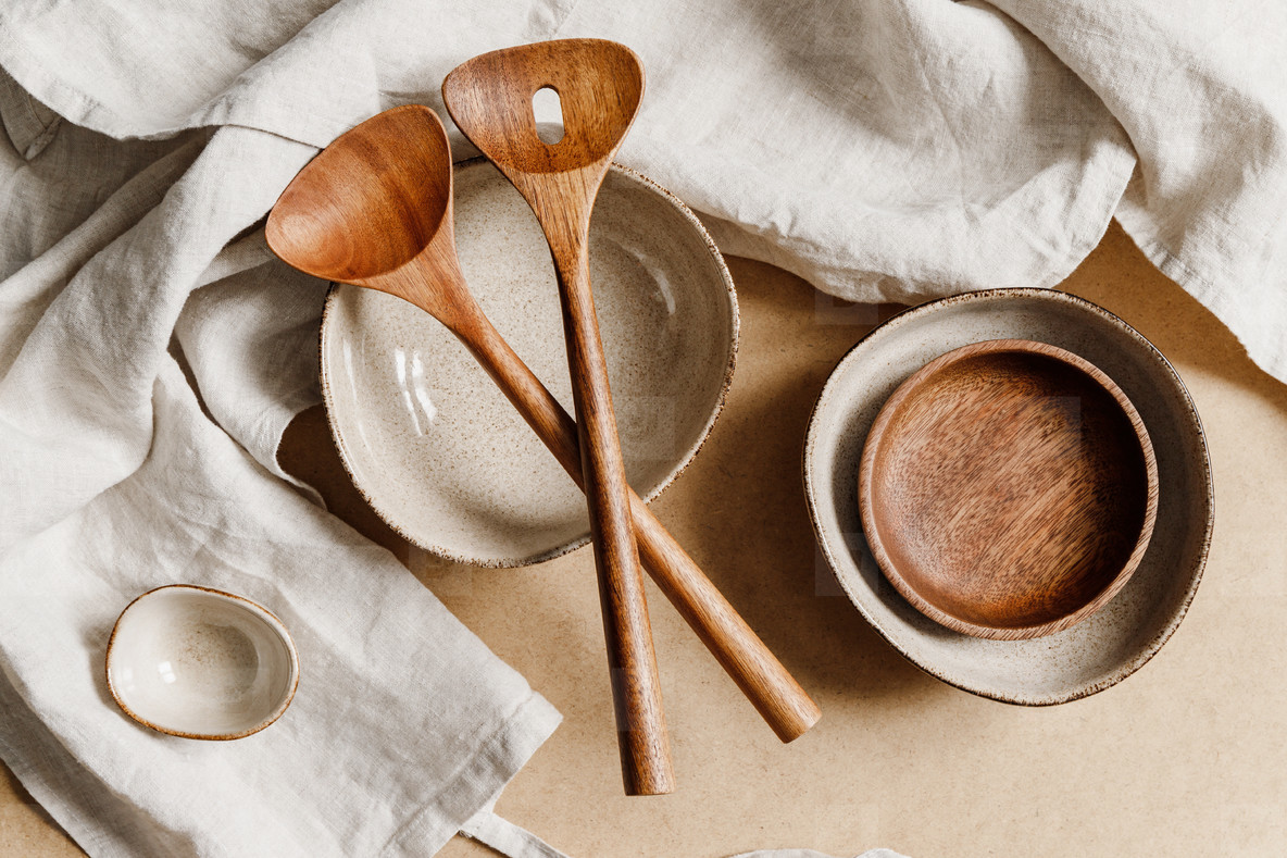 Modern minimalist ceramics set over a linen cloth. Natural products or food concept, top view, flat lay.