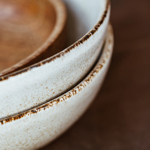 Macro abstract photography of modern minimalist ceramics set and wooden bowl