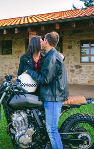 Couple kissing with custom motorcycle