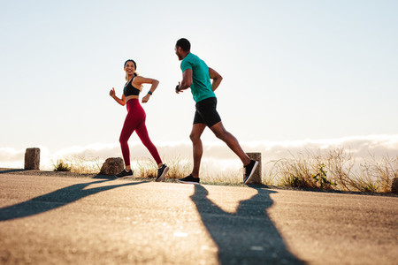 Fitness couple running on road