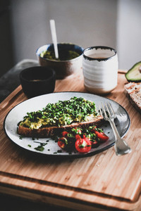 Healthy breakfast with avocado toast and espresso coffee on board
