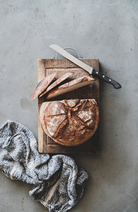 Freshly baked sourdough wholegrain bread on rustic wooden board