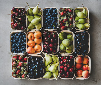 Summer fruit and berry assortment in wooden boxes