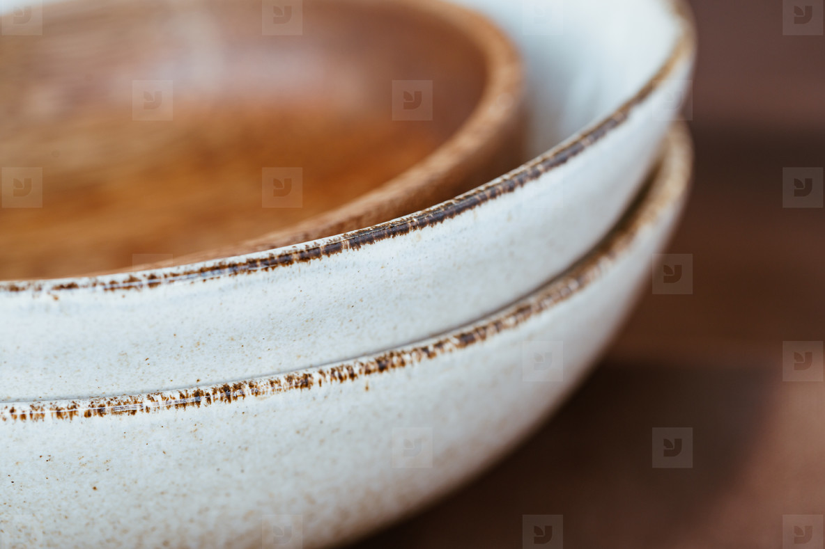 Macro abstract photography of modern minimalist ceramics set and wooden bowl