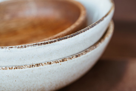 Macro abstract photography of modern minimalist ceramics set and wooden bowl