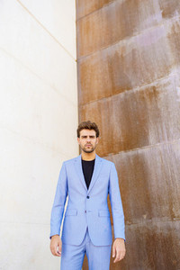 Attractive man wearing suit standing in urban background
