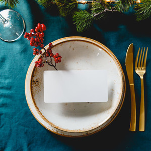 Festive table setting with winter decor and mockup  The concept of Thanksgiving or Christmas family dinner