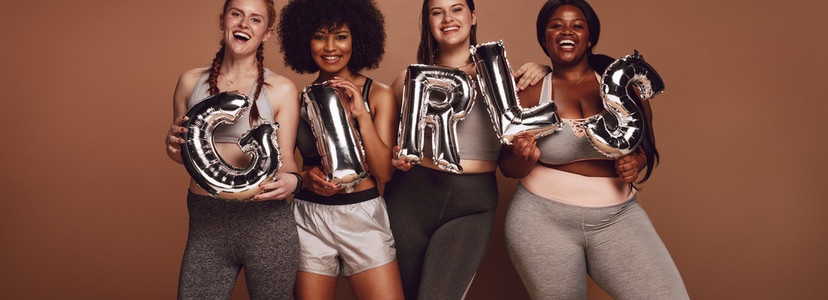 Diverse group of women with girl word in balloon letters