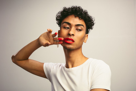 Transgender male smudging his lipstick