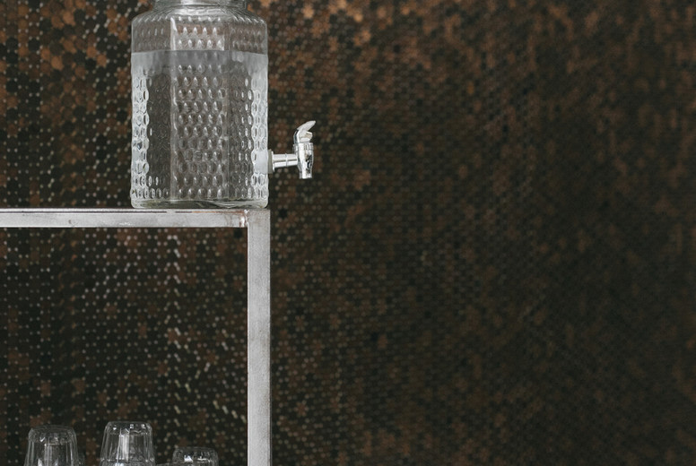 Water dispenser and glasses on restaurant shelves