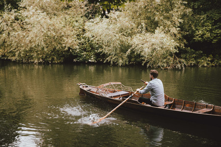 Man rowing canoe on tranquil River Avon Bath Somerset UK