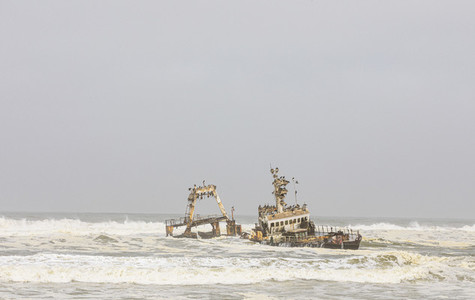 Shipwreck in ocean surf Torra Bay Namibia