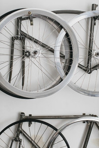 Bicycle rims and frames hanging on wall