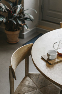 Tea and teacup on wooden dining table