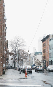 Snow falling over urban street Brooklyn New York USA