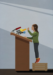 Girl standing on crate at podium with microphones
