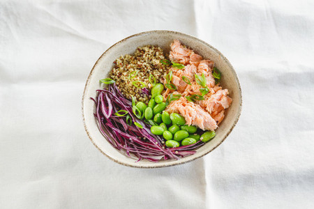 Poke bowl with couscous baked salmon bean and cabbage Healthy eating concept