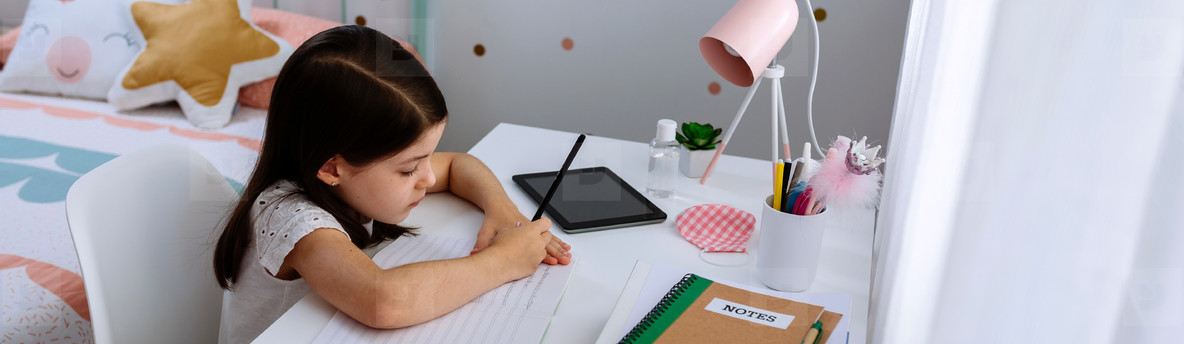 Girl studying at home with mask on table