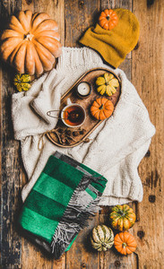 Flat lay of fall trendy women apparel layout over rustic background