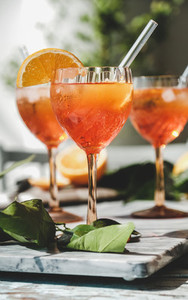 Aperol cold cocktail in glasses with fresh oranges