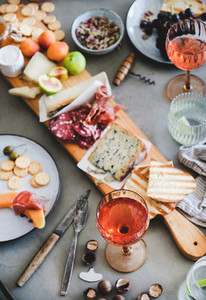 Mid summer picnic with rose wine  cheese  charcuterie  appetizers and fruits