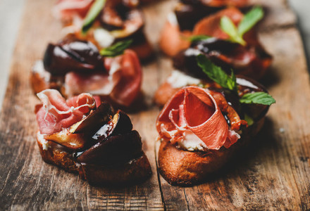 Crostini with prosciutto  goat cheese and grilled figs on board
