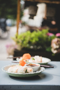 Fresh vegan rice paper summer rolls on table in cafe