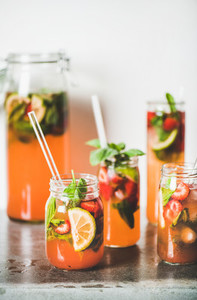 Fresh homemade strawberry and basil lemonade in tumblers with straws