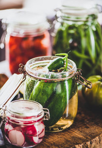Ingredients and jars with homemade vegetables preserves