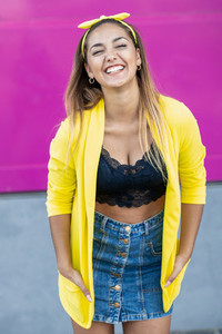 Young woman wearing a yellow jacket and headband
