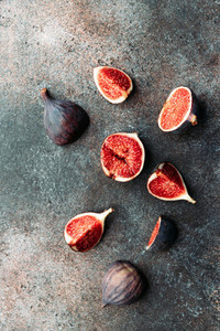 Top view of fresh ripe cutted figs on the textured background