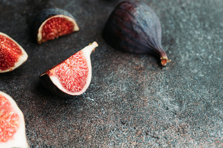 Macro photography of fresh ripe cutted figs on the textured background