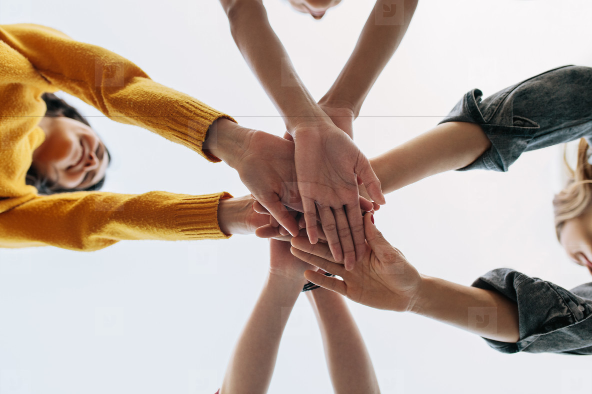 Friends putting their hands together for unity and teamwork stock photo  (218700) - YouWorkForThem