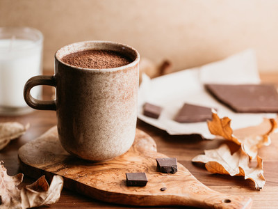 Close up of hot chocolate in a ceramic mug on the table  Autumn or winter cozy still life