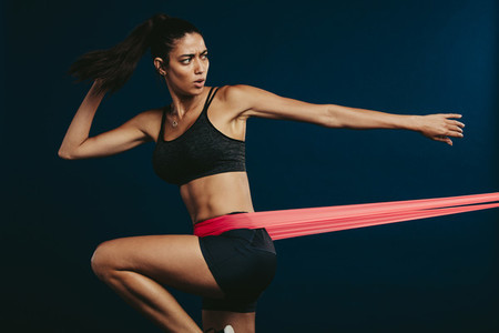 Woman exercising with elastic band